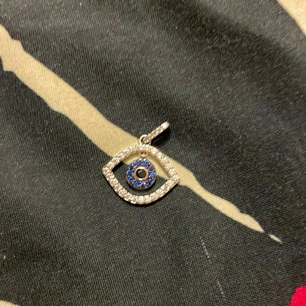 Evil eye pendant with blue and silver cubic zirconia.
